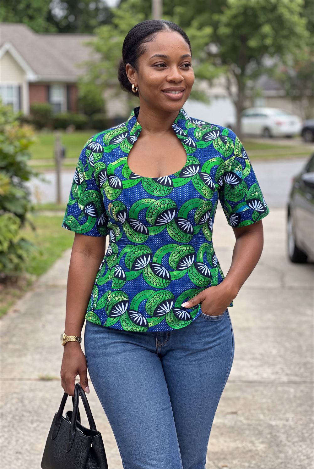 Illustration of a MariFel design: fitted blue and green wax-print top with a stand-up split collar and keyhole neckline, styled with jeans